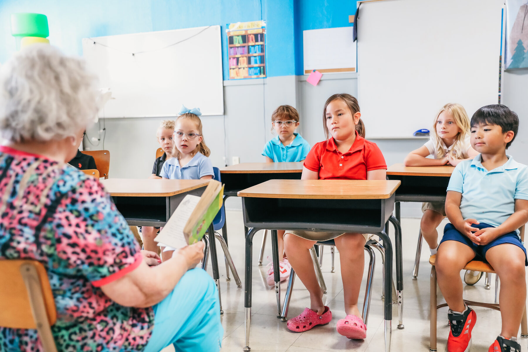 A Trinity Christian Academy teacher reading aloud to her students